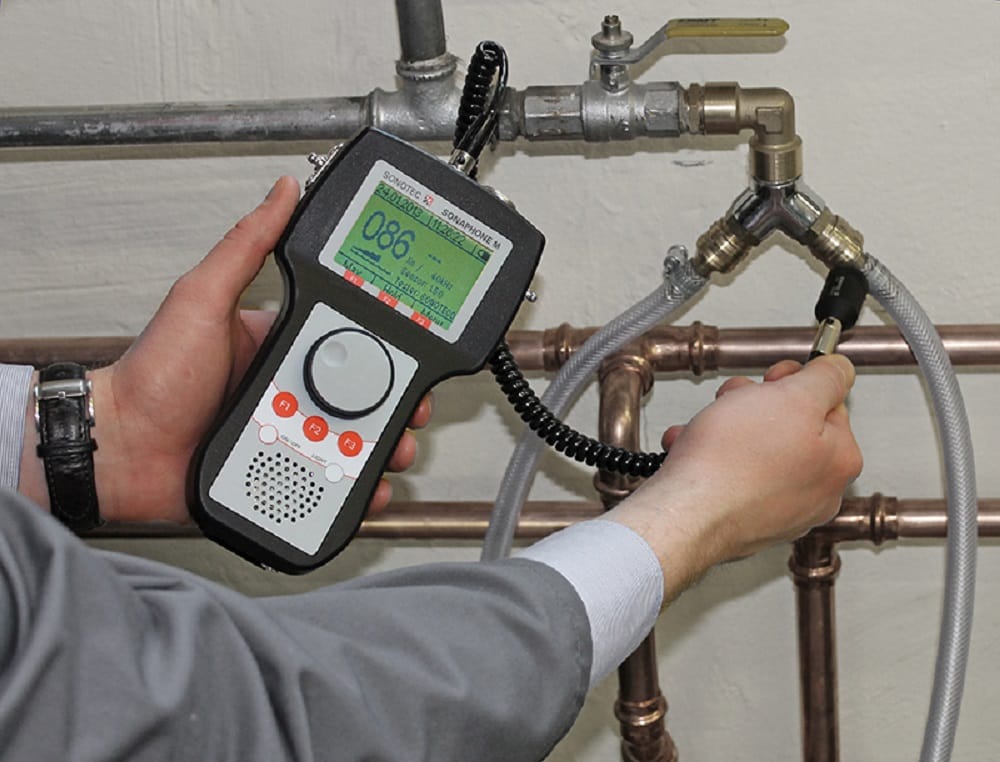 Plumber testing pipes with electronic leak detection equipment in North Miami Beach
