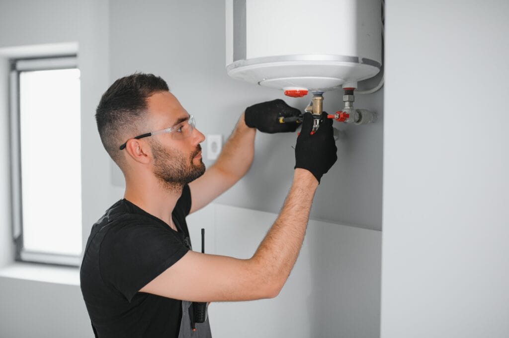 Technician performing water heater maintenance in North Miami Beach